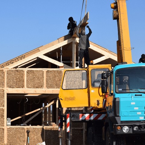Straw panel home in the making with a crane