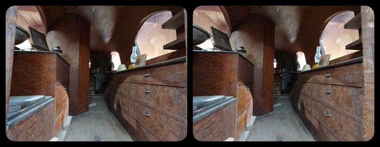 A vintage vehicle displayed in a museum. It is a sort of recreational vehicle, and the body is made from a single piece of redwood.