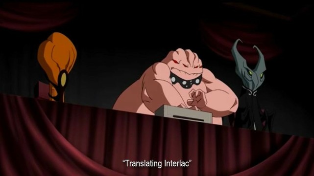 A tribunal of three different-looking aliens, one that is a squid-like blob, one that is large and fleshy with four eyes, and one that is sort of bug-like with a split head. The subtitle reads, “Translating Interlac.”