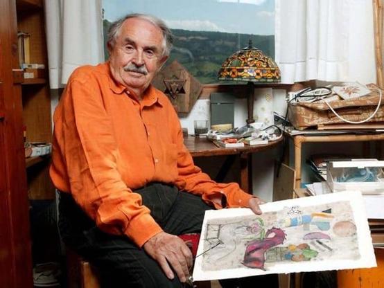 Tonino Guerra, wearing bright orange shirt, holds an abstract painting in his hand