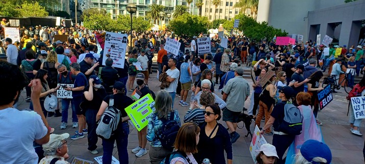 A crowd of people holding signs in Pershing Square, Los Angeles -- getting ready to march to City Hall to protest the anti-constitutional bullshit the Trump regime and Republicans are getting away with. #TrumpMustGo