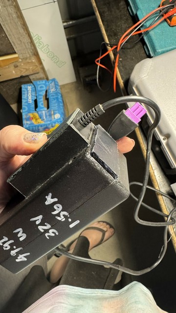 The overall power supply package, in my hand. It still has the paint marker on the side but the top box is done and the purple 3-pin female plug too. The solvent-cemented panels look a bit rough so I just need to bevel and tidy them.
