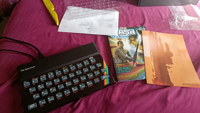 My new The Spectrum console, freshly unboxed with specially created mini Crash! magazine booklet  (A popular Speccy Magazine of the period) and the instructions using a facsimile of the famous image from the original rhino-stunning book of How To Code BASIC that came with the original machine. The console is in the shape of the old rubber-keyed 48K speccy but has more advanced innards capable of emulating later machines as well as five USB ports - four for gamepads.