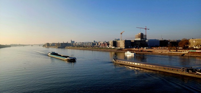 Two river boats on the Rhine in front of Mayence's sky line.