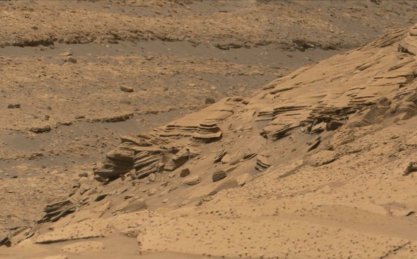 An ochre toned image of a ridge captured by the Mars rover Curiosity.
