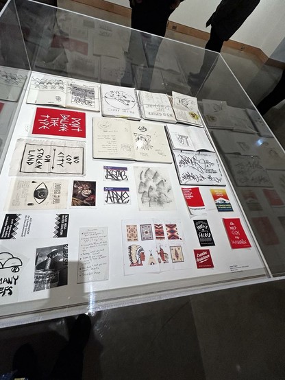 A vitrine with various small drawings and notes