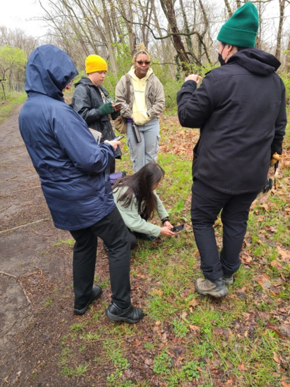 i'm on the right with a green beanie and a mask holding a mushroom to describe the morphology to the attendees around me.