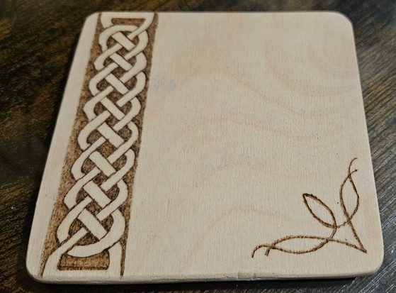 A demo coaster I made (hence the rough edges) to test a different type of material, burning at a cooler temperature and trying to get the Celtic knot pattern straighter.