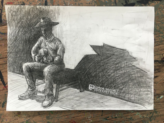 A person with a cowboy hat sitting on a flat stool, playing the guitar. They throw a big and dynamic shade to the right, on a wall in their back. Another crosshatched shade on the left.