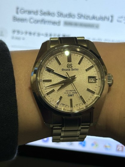 Wrist shot of the Grand Seiko SBGJ201 aka Mt Iwate with a reservation to tour Studio Shizukuishi in the background