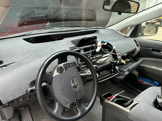 The disassembled dashboard of my Prius. Plastic covers have been put aside, so that the touch screen could be removed and fixed.