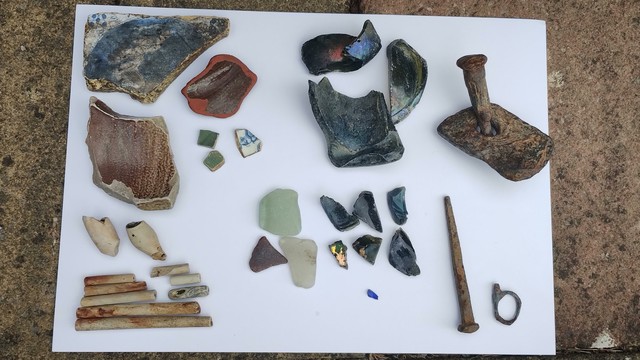 The same display of mudlark finds from the Thames Foreshore, as previous photo but some of the pottery pieces have been flipped over to show the other side.