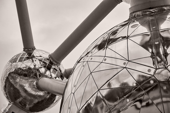 All three images are details of the Atomium: 9 gigantic (18m diameter) Stainless steel clad spheres joined together with steel tubes (which hold the escalators and elevators) shaped together in unit cell that represent an iron crystal, magnified 165 million times.