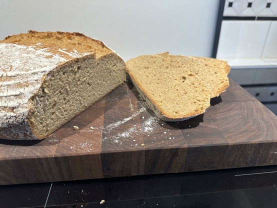 A loaf of khorasan bread with some slices cut off showing the crumb with fine to medium pores.