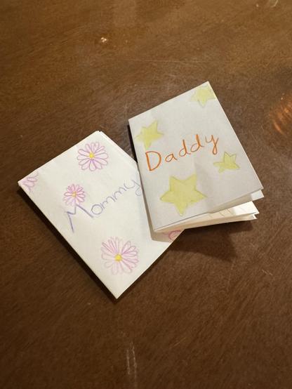 single sheet foldable comics that say “mommy” and “daddy” on their covers