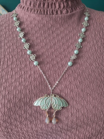Hand painted butterfly necklace by MercuRea, light mint beads and medieval rosettes intertwined to create the chain and glass drop beads in the tail of the butterfly