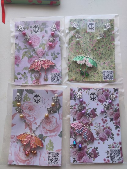 Other colours available of the butterfly necklace by MercuRea shown from left up to bottom right, pink and rose, vibrant green and light pink, pink and orange, lilac and blue