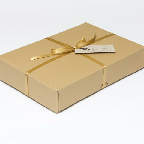 Picture shows a closed A4 box tied with gold ribbon.