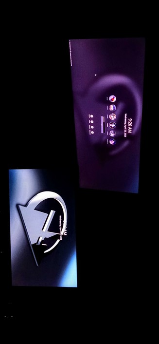 The photograph shot in total darkness consists of two IPS LED panels, each displaying different content. The top screen shows a dark purple background with a circular design in the center. It features a time display reading "9:26 AM" and a date "Wednesday, April 26, 2023." Below the time, there are several circular icons, likely representing different users applications or media options, with a progress bar in the middle. The bottom screen displays a logo with a stylized "K" inside a triangle, set against a dark background with a blue gradient. The logo is accompanied by the text "Wednesday, April 26, 2023," matching the date on the top screen. The overall color scheme is dark with purple and blue tones, creating a sleek and modern appearance.

 Ovis2-8B

🌱 Energy used: 0.196 Wh
