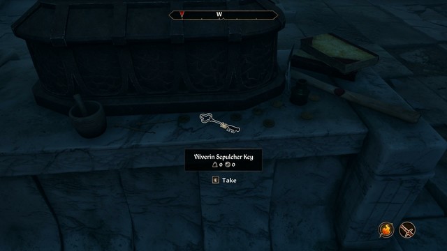A key to a locked door is found near the necromancers stuff.