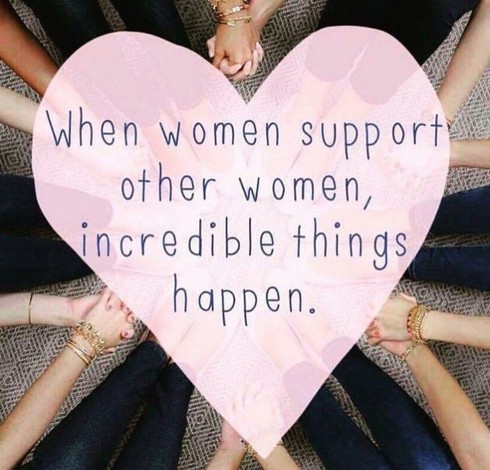 An image showing the hands of multiple women of various skin tones joined together in a circle, symbolizing unity and support. Each individual is wearing jeans, and several are wearing bracelets. A light pink, textured heart is centered over the hands. Inside the heart, dark blue text reads, "When women support other women, incredible things happen." The photo is intended to be inspirational, and promotes female empowerment.