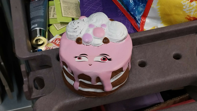 One of those stress ball things, but it's a cake with a severely lazy-eyed face
