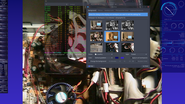 The image shows a computer's internal components with a partially open window displaying a background settings dialog box. The background of the dialog box features a selection of images, including a desktop scene and various computer-related images. The dialog box is titled "Background" and includes options for "Menu," "Wallpaper," "Folder," and "CasePics." The selected background is a desktop scene with a computer monitor. The dialog box also offers settings for "Style" (including "Vertical gradient," "Horizontal gradient," and "Scaled"), "Apply to all workspaces," and "Random Order." The "Change the background" button is visible, along with a "Help" button. The background of the dialog box is dark, with a blue sidebar on the right displaying system information, including temperature, CPU usage, and other metrics. The left side of the image shows a terminal window with lines of code and system information, including CPU and memory usage. The overall color scheme is a mix of dark and blue tones, with the computer's internal components in various shades of red, black, and silver.
