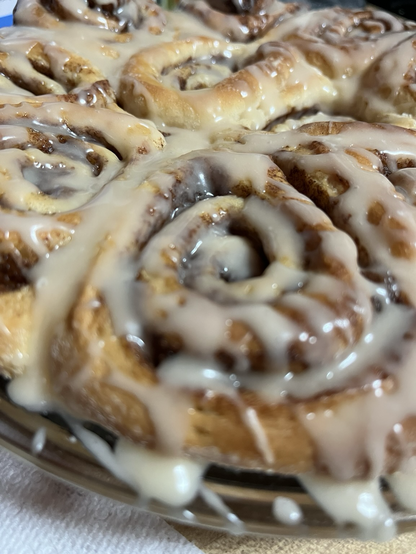 Super up close photo of extra glazed cinnamon rolls