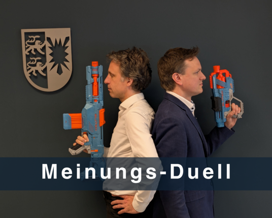 Marc und Thilo stehen Rücken an Rücken in einem Gerichtssaal. In ihren Händen halten sie Spielzeugpistolen. An der Wand hängt das Landeswappen. Text: Meinungs-Duell
