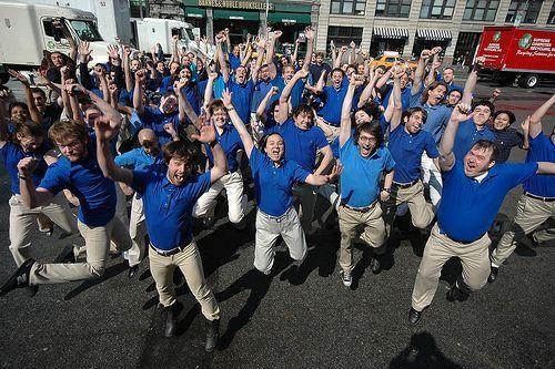 Say Yes: photograph of a large group of workers wearing blue shirts striking dramatic triumphant poses outdoors. Image attribution: http://www.flickr.com/photos/feastoffools/ / CC BY-NC-SA 2.0