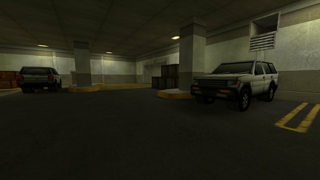 In this picture you can see the view from in front of the stairs from the last picture of the previous photo series. From left to right you can see two light wooden boxes, the second white SUV, a pillar where behind a wooden box to the left of the column is visible, an entrance / exit, three darker wooden boxes, another column, the first white SUV and where above it is an open ventilation shaft. Furthermore, you can see three yellow-lit lamps on the ceiling. This is on the map cs_siege in the game Counter-Strike 1.6.