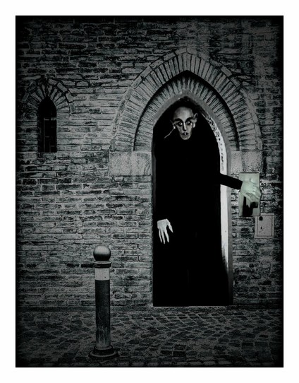 Nearly exactly the same scene as before but darker. This time his hand is lower down as he has flipped the light switch off.