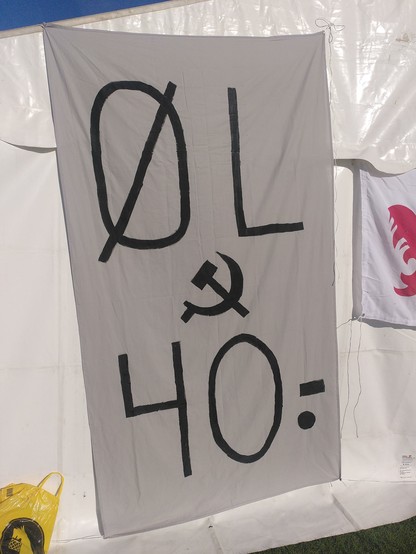 Grey banner with big letters reading "ØL" (beer), a hammer and sickle and the price