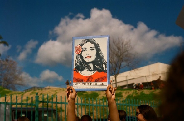 Women holds up a sign that reflects Barack Obama’s campaign image, but representing a Latina woman, during the 2017 Women’s March in Los Angeles, CA.