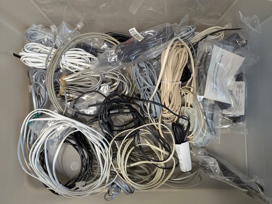 a pile of analogue telephone cords in a bin