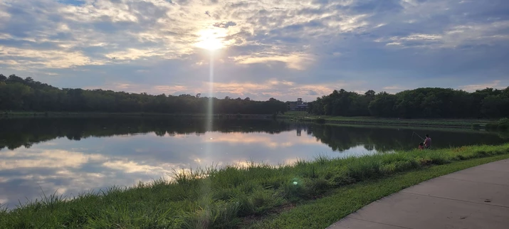 Warm summer day, father and child fishing at the pond