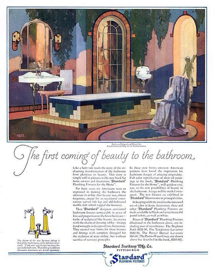 A beautiful bathroom with colorful tile and white fixtures is seen. There’s a chair with a bathrobe thrown over the back.