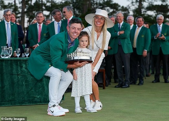 Rory McIlroy poses with wife Erica and daughte Poppy after winning the Masters in April