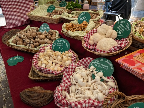 A stapl with baskets of mushrooms