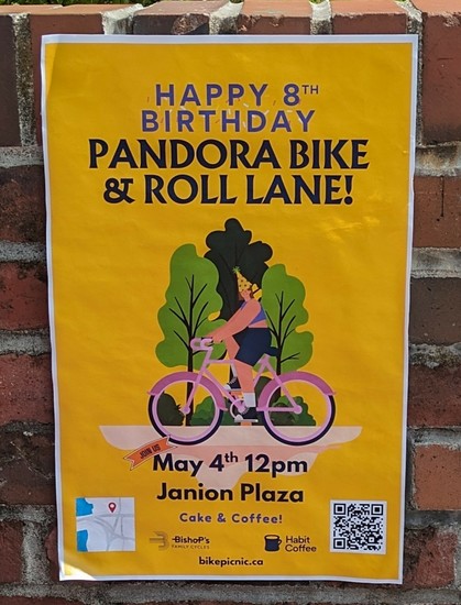 A yellow poster announcing coffee and cake at the Janion Plaza in the City of Victoria to celebrate the 8th anniversary of the installation of a protected bike lane on Pandora Avenue.