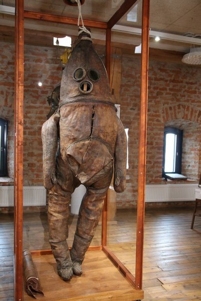 Wanha Herra standing inside the display case