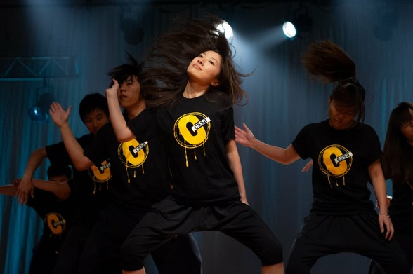 Dancers on stage whipping their hair around during the performance.