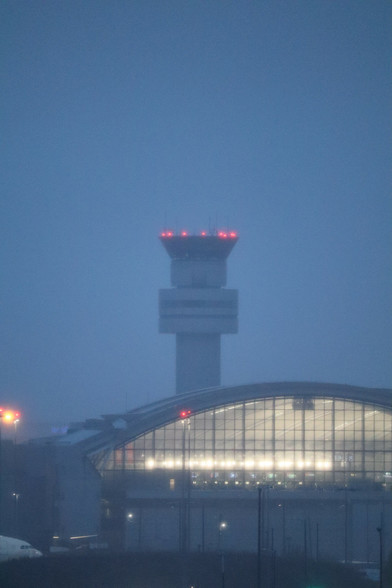 Picture during rain and dusk of Pearson airport's main control tower.