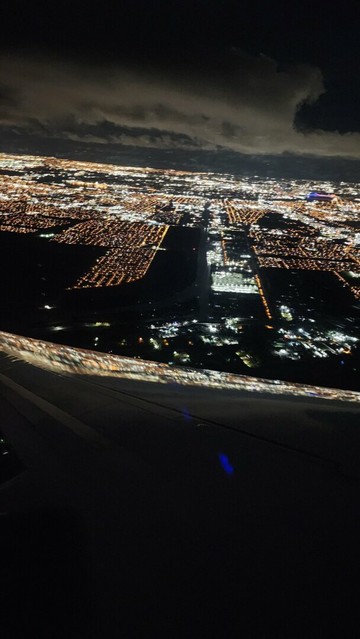 Shot of New Orleans through the window of an airplane at night.