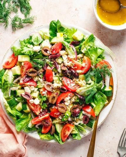 Mediterranean Salad on plate with dressing.
