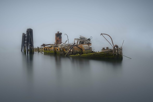 The Mary D. Hume was built in 1881 in Gold Beach, Oregon, and served for nearly a century as a cargo vessel, whaler, tugboat, and more. After her retirement in 1977, she returned to Gold Beach and sank in 1985, where her remains still rest. I’ve seen her many times, but conditions never felt quite right for a photo—until this foggy October day. With a minimalist, atmospheric look in mind, I used a long exposure to soften the water and enhance the mist. The fog didn’t quite hide the jetty clutter behind her, so I cleaned it up in Photoshop to isolate the wreck. I kept the image in color for now—those mossy gunnels and faded paint really tell her story.