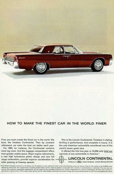 "How to make the finest car in the world finer." The car is seen from the rear and to the side. It is a dark red.