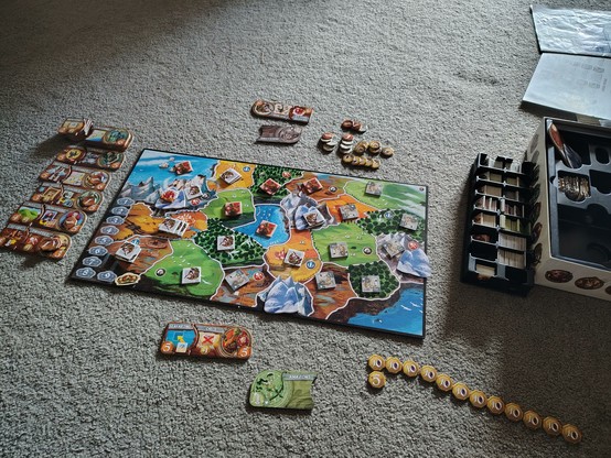 End game of the Small World board game. At the bottom of the picture, an alarmingly large row of coins is laid out. That is my daughter's score.