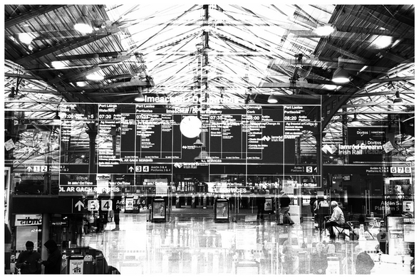 Departures board in Heuston Train Station, Dublin. Rooflights, timetables and people waiting to get through time.