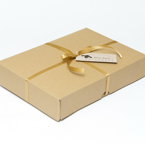 Picture shows a closed A4 box tied with gold ribbon.